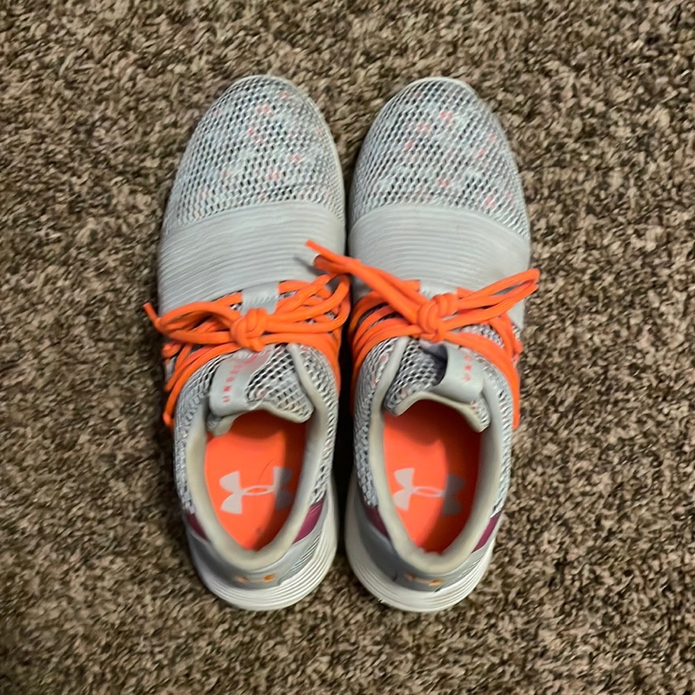 I am selling athletic under armor shoes in gray and orange.